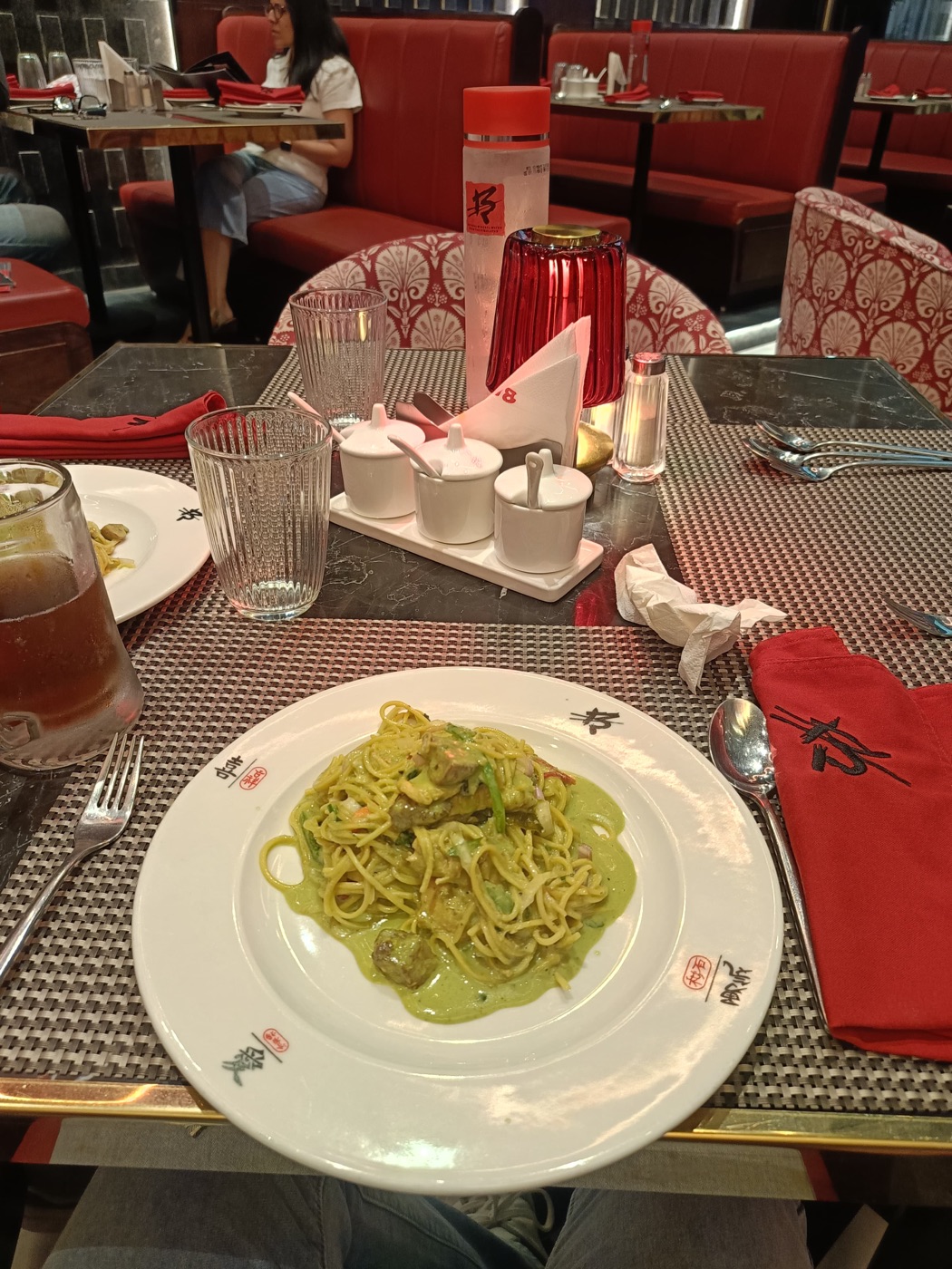 Pasta and drinks on a warmly lit dinner table